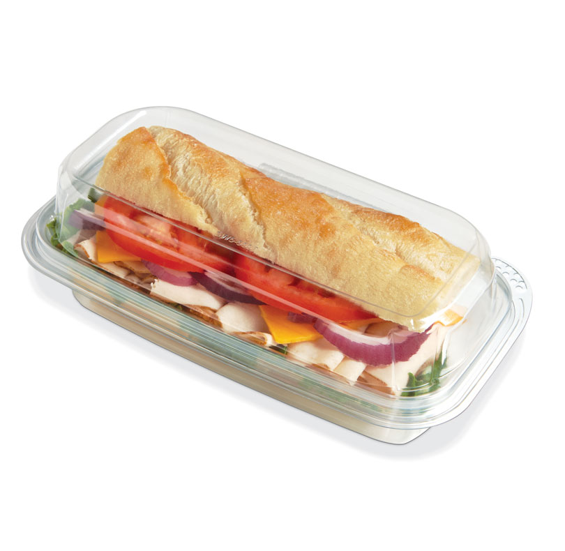 Baguette sandwich with lettuce, tomatoes, onions, peppers, and cheese in a clear container