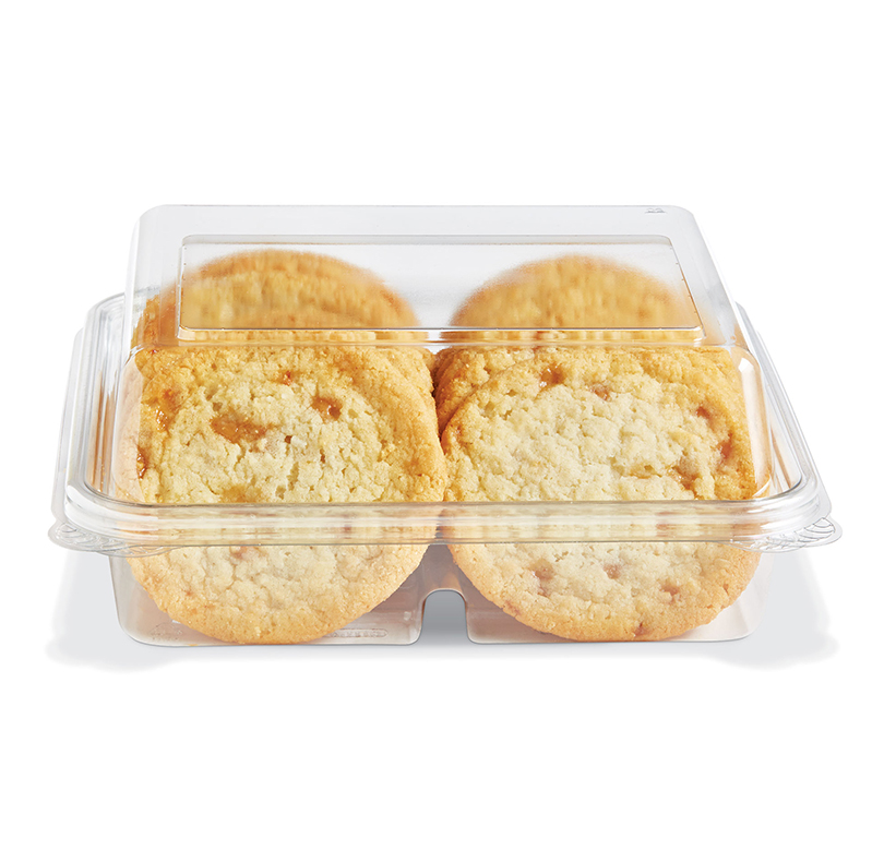 Four golden cookies in a clear plastic container