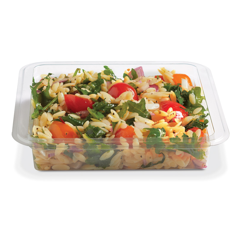 Container of orzo pasta salad with tomatoes, leafy greens, onions, and herbs