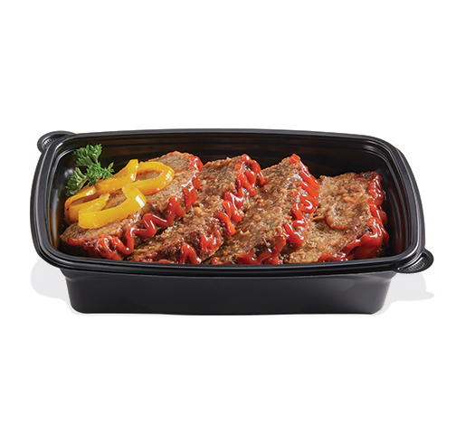 Sliced meatloaf topped with ketchup and yellow peppers in a black tray