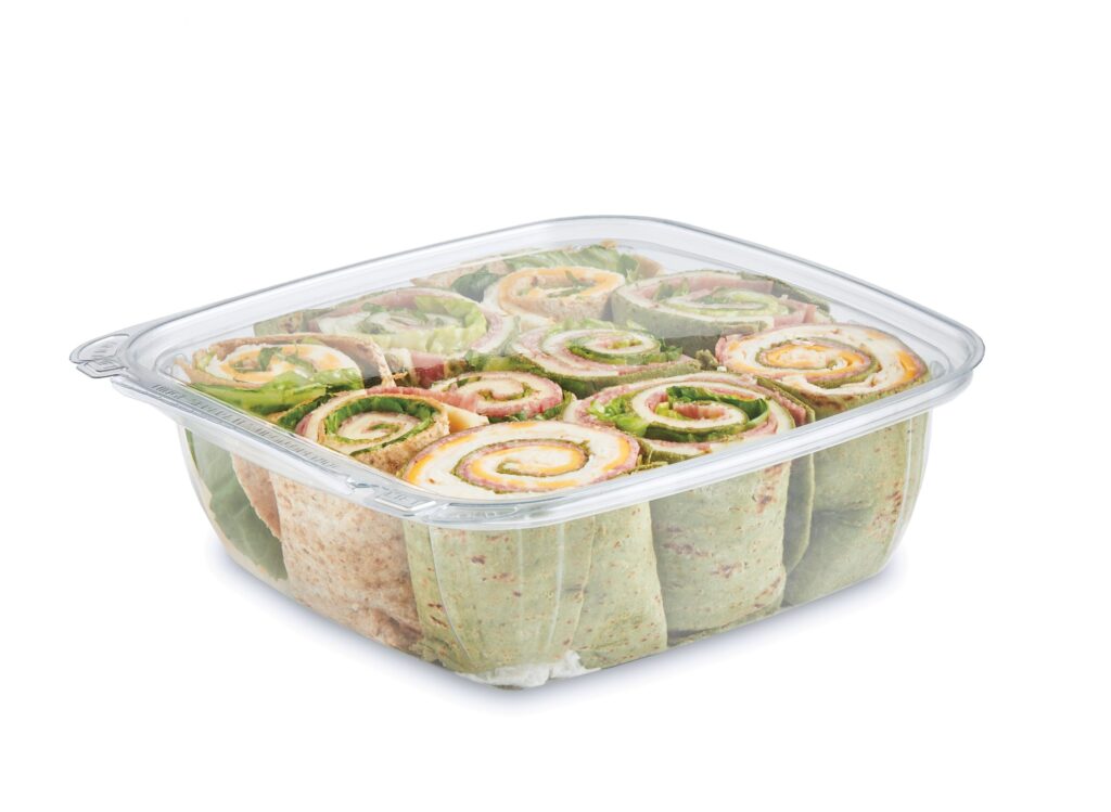 Tray of sliced pinwheel wraps filled with lettuce, deli meat, and cheese