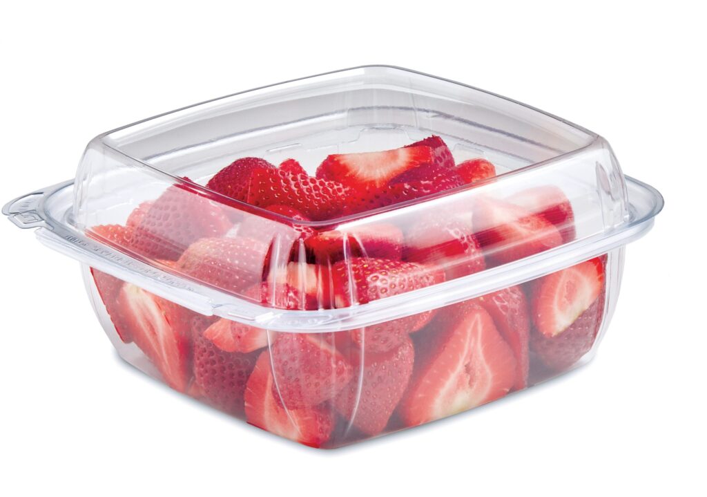 Sliced strawberries in a clear plastic container with a lid
