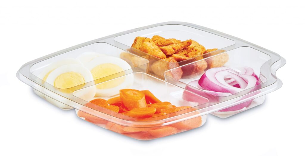 Divided serving tray holding fried snacks, sliced carrots, boiled eggs, and red onions