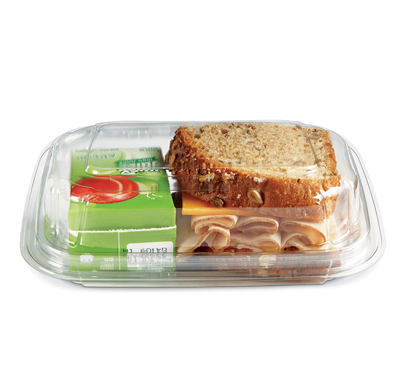 Packaged lunch tray with a sandwich, rolled deli meat, cheese, and a green fruit cup
