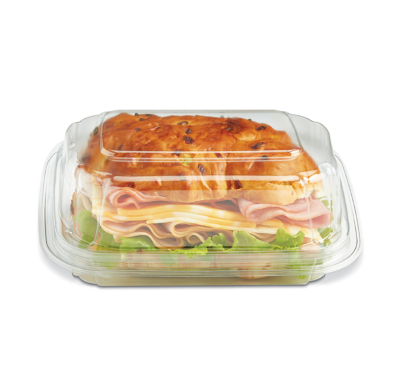 Layered ham and cheese sandwich with lettuce in a glass container