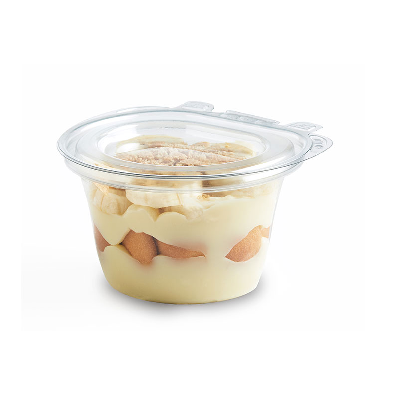 Clear cup of layered banana pudding with vanilla wafers and banana slices