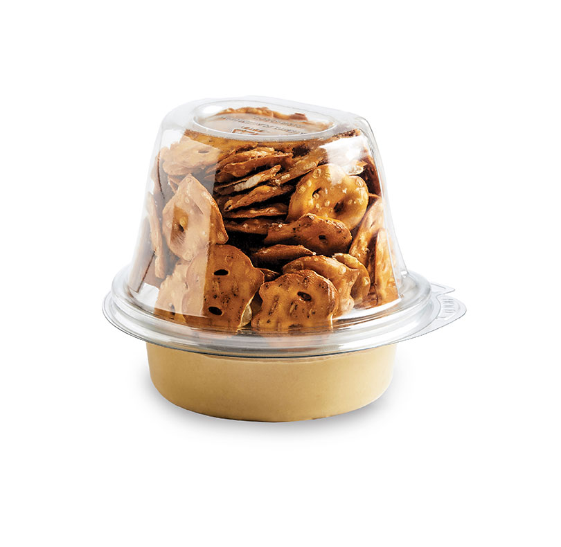 Container of assorted pretzels with a dipping sauce cup underneath