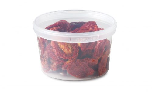 Clear plastic container filled with sun-dried tomatoes