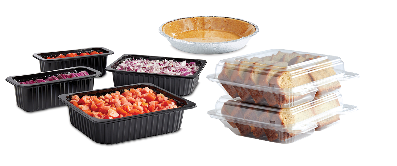 Black food trays with chopped vegetables, an empty pie crust, and stacked clear containers holding baked goods