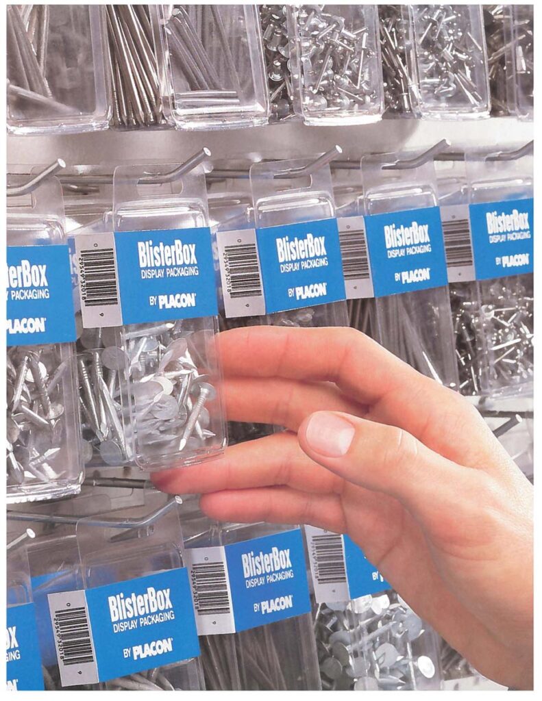 Hand holding a BlisterBox package of nails among similar hardware packages