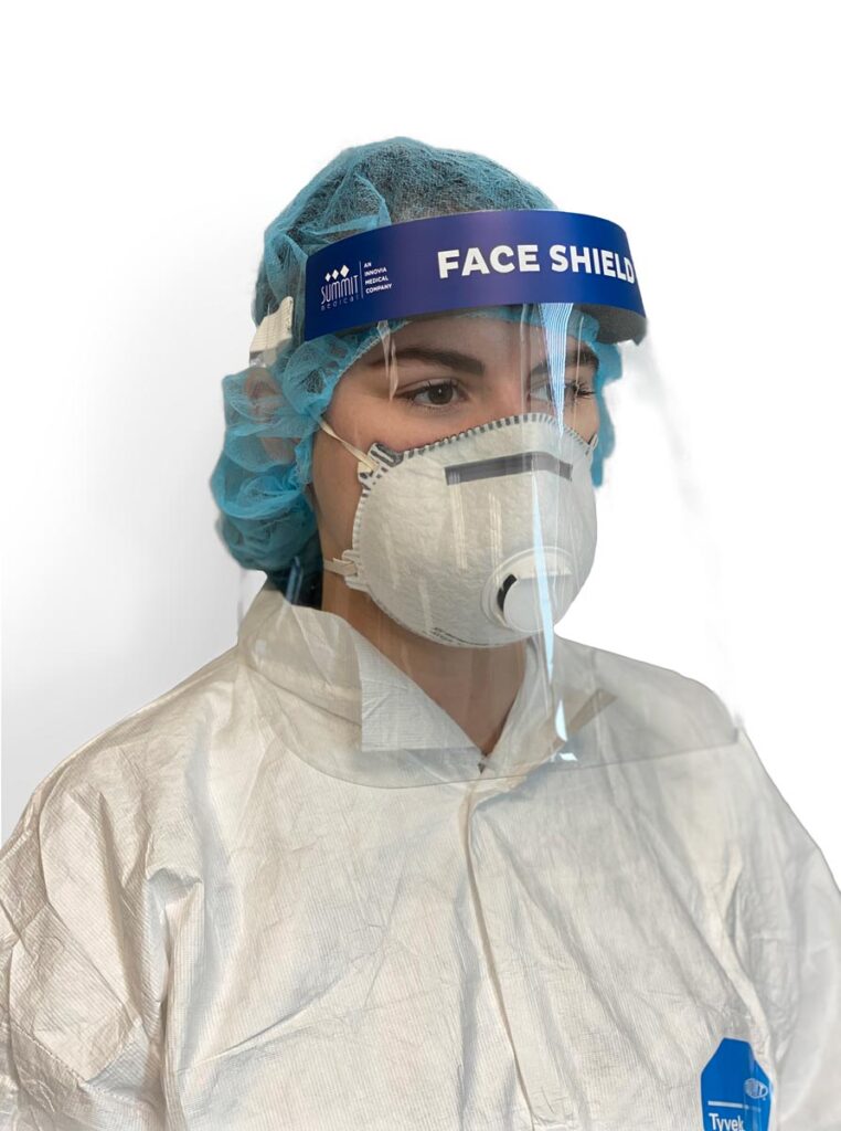 Healthcare worker wearing a face shield, respirator mask, hair cover, and protective gown