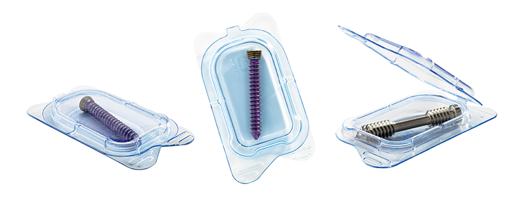 Three transparent packages containing purple and metal threaded medical devices, with tweezers above the right package